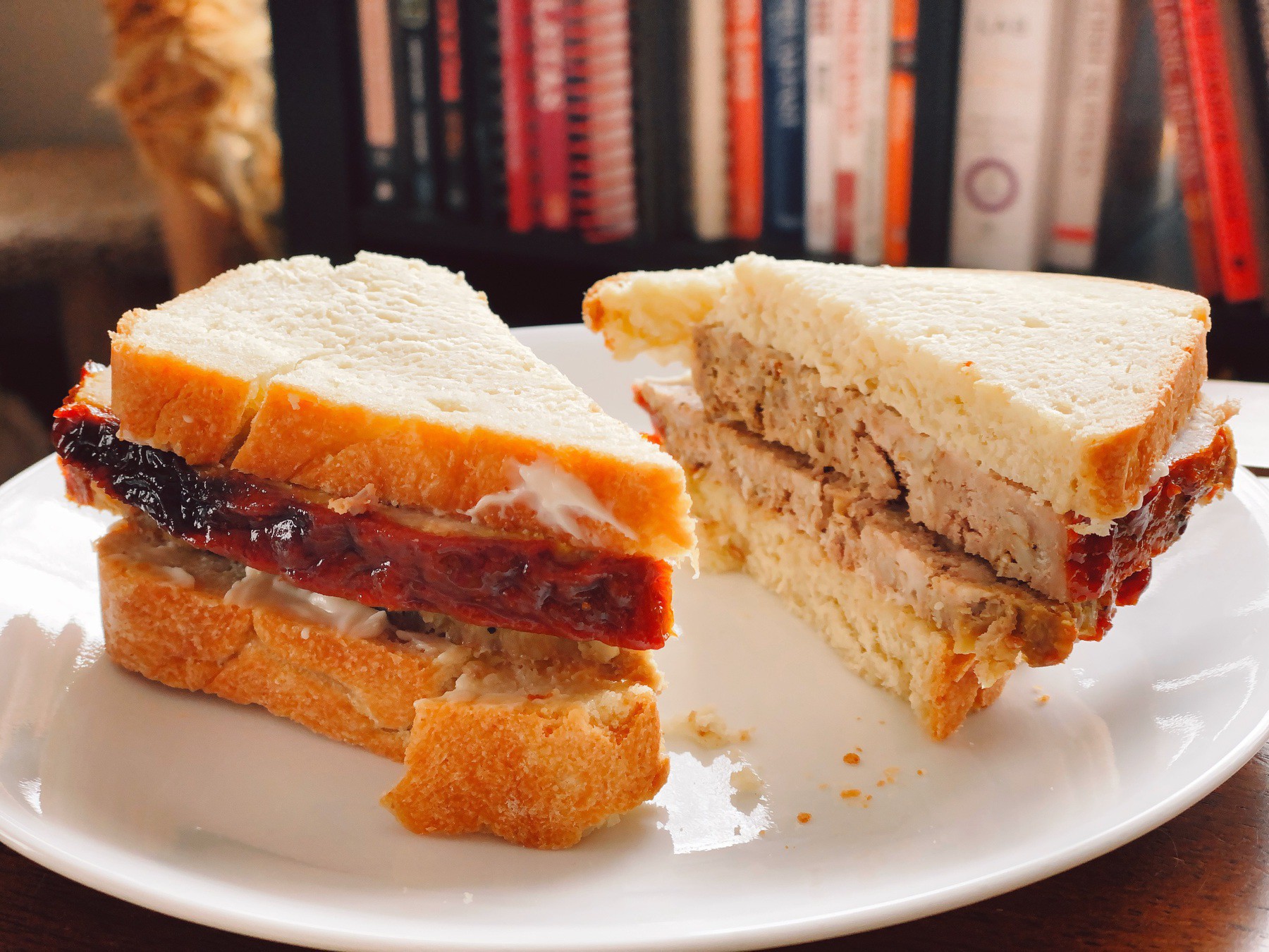 Sandwich of sliced homemade meatloaf on homemade bread.